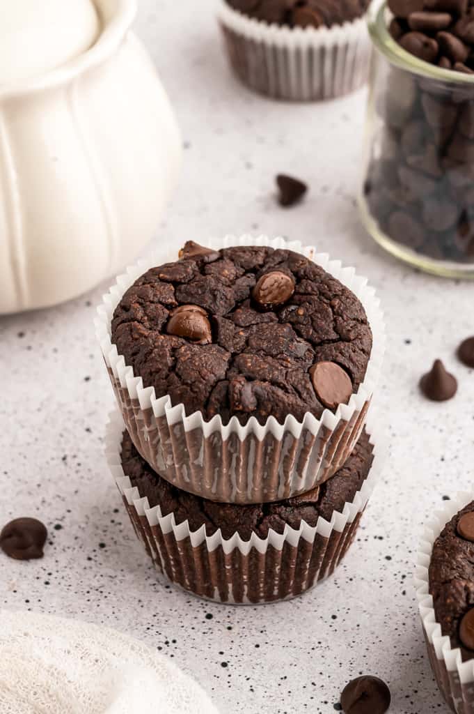 Two homemade chocolate protein muffin stacked on each other.