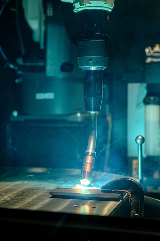 Image of robotic MIG gun welding a piece of metal