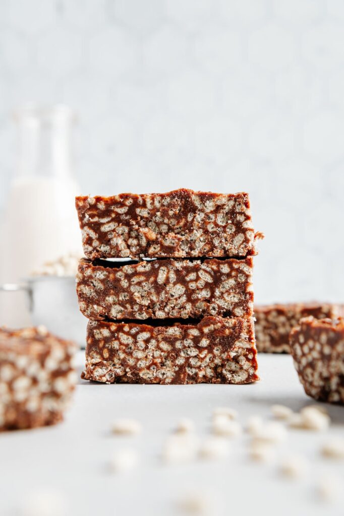 Three chocolate rice krispie treats stacked on top of one another.