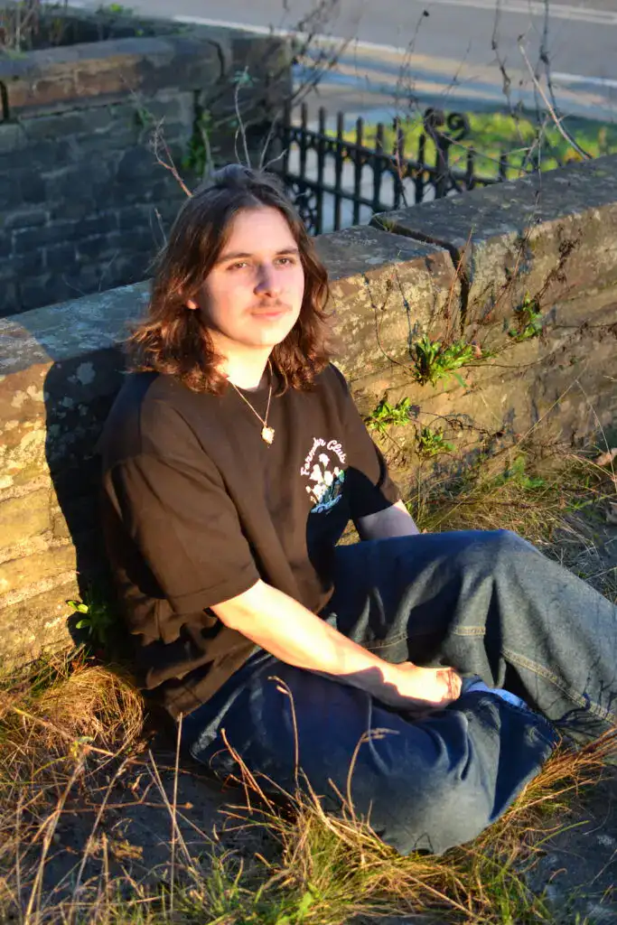 Adam is sitting in the sun pensively