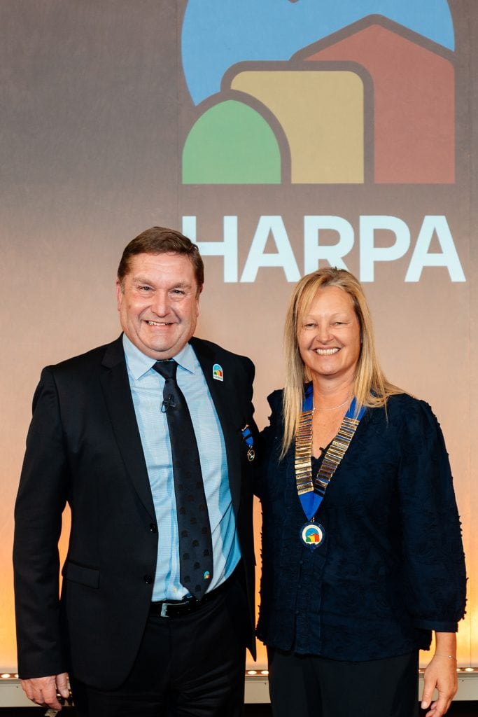 Retiring chair of HARPA Ian James passes the chains of office to Claire Flower for her two-year tenure
