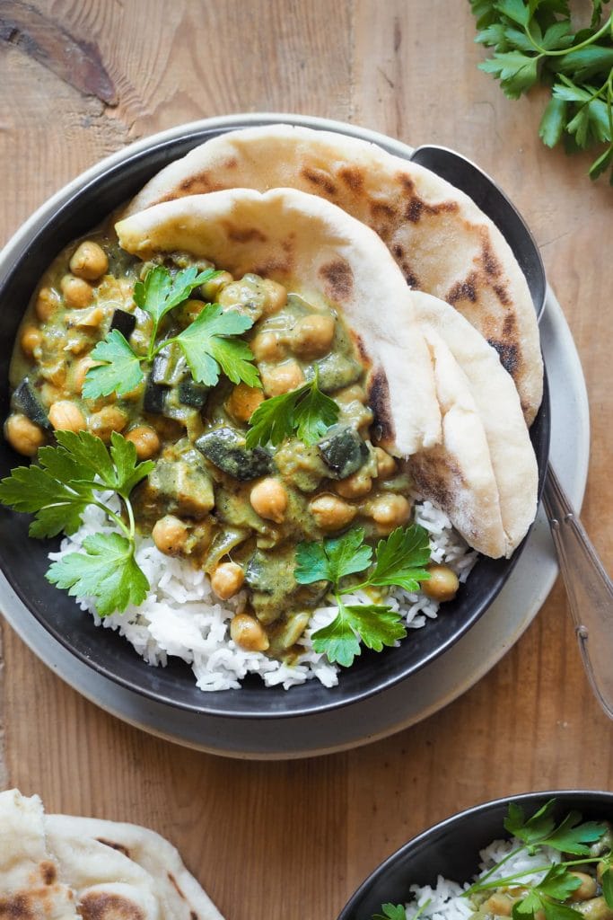 Paula's Apron 30 Minute Chickpea Aubergine Curry This 30 Minute Chickpea Aubergine Curry recipe is perfect for a weeknight meal. It's quick to make, simple and incredibly! Serve over basmati rice and with a side bread to top it up a notch. And by the way, it's naturally is vegan, gluten-free and lactose-free. What else can one ask for? In this overhead shot we can see the curry served over rice on a plate with some flat bread and a spoon next to it.