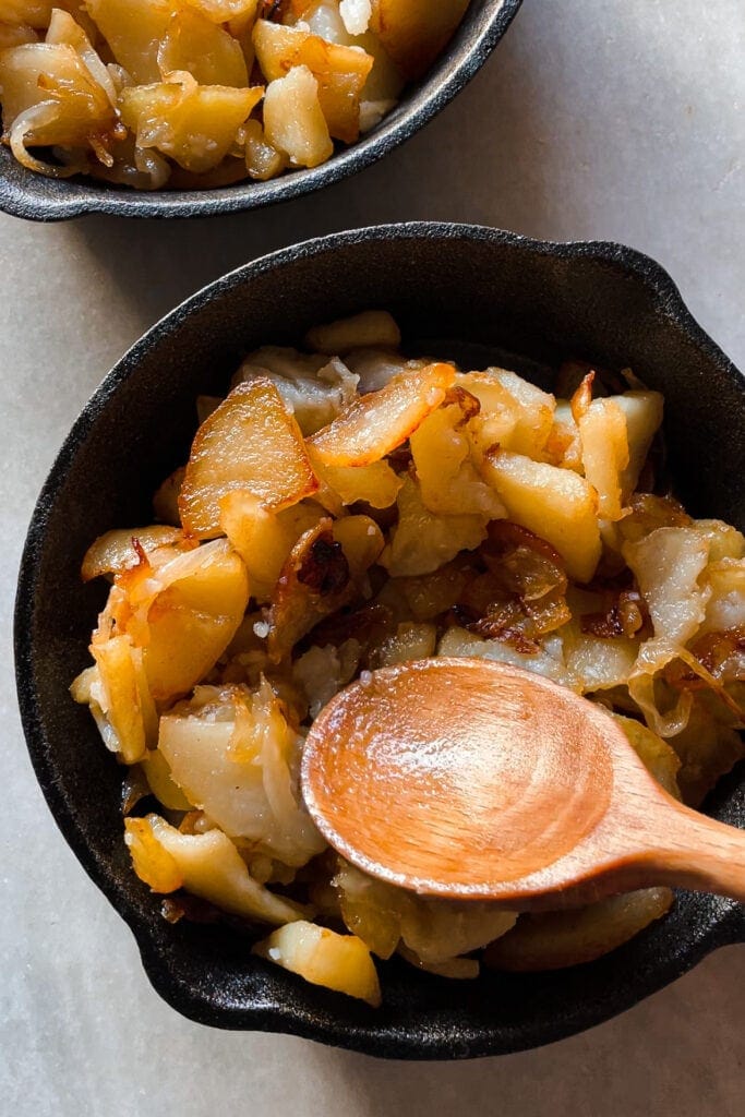 Paula's Apron Cheesy Baked Eggs with Potatoes Fried potatoes and onion for the Cheesy Baked Eggs with Potatoes recipe. It's a simple and easy dish that calls for less than a handful of ingredients. Grown ups and children love it alike which makes it always a big hit! Simply perfect, and even more so if I tell you that it's one of my grandma's recipes. | Paula's Apron Recipe