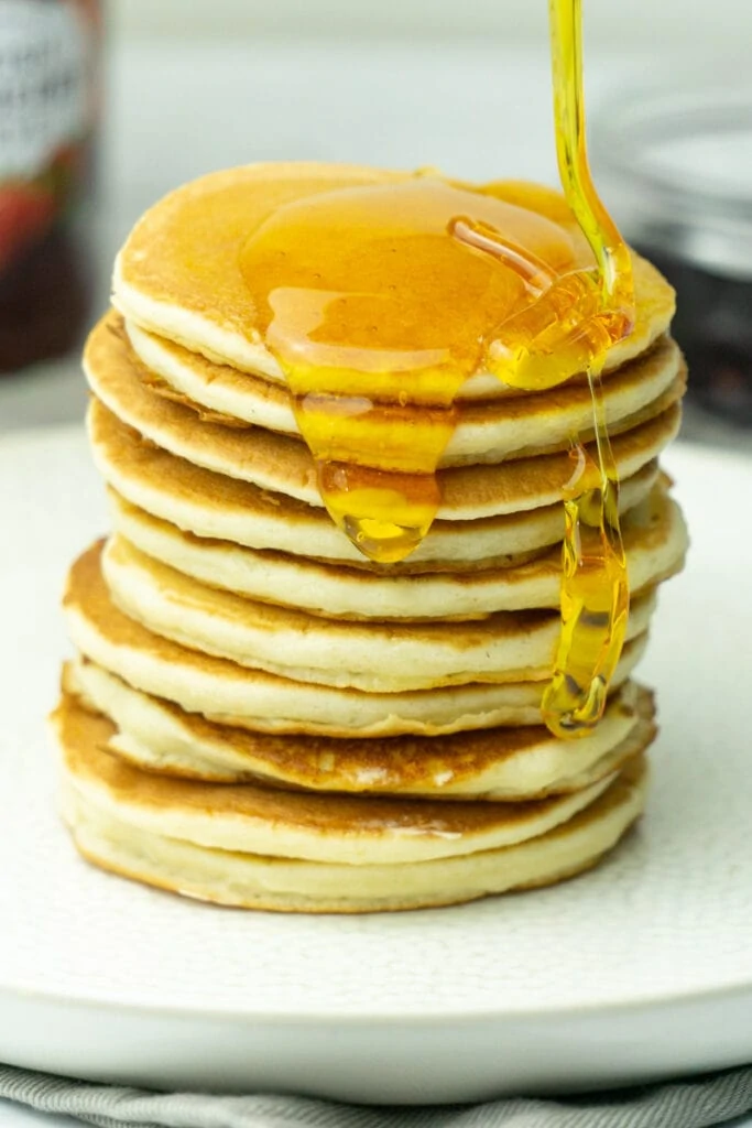 Scottish Pancakes, Drop Scones, or Scotch Pancakes in a stack with syrup