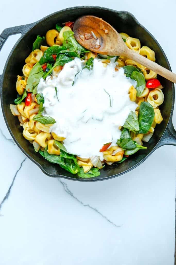 Enjoy the fresh taste of tortellini, shredded cheese, baby spinach, and tomatoes mixed to create this tasty and fulfilling Creamy Tortellini Pasta Skillet