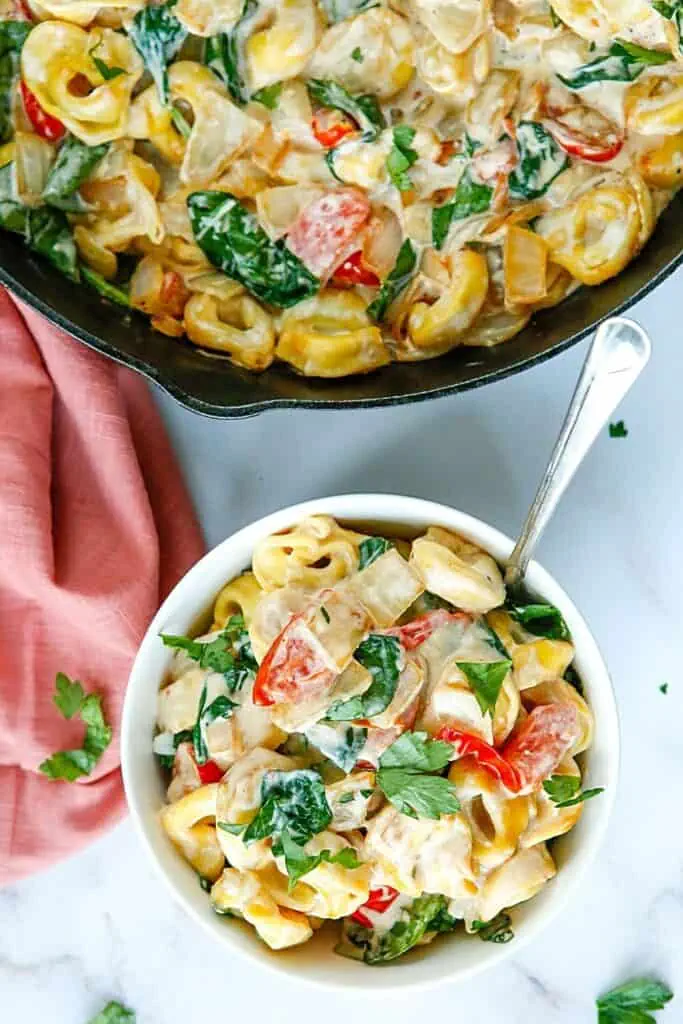 Enjoy the fresh taste of tortellini, shredded cheese, baby spinach, and tomatoes mixed to create this tasty and fulfilling Creamy Tortellini Pasta Skillet