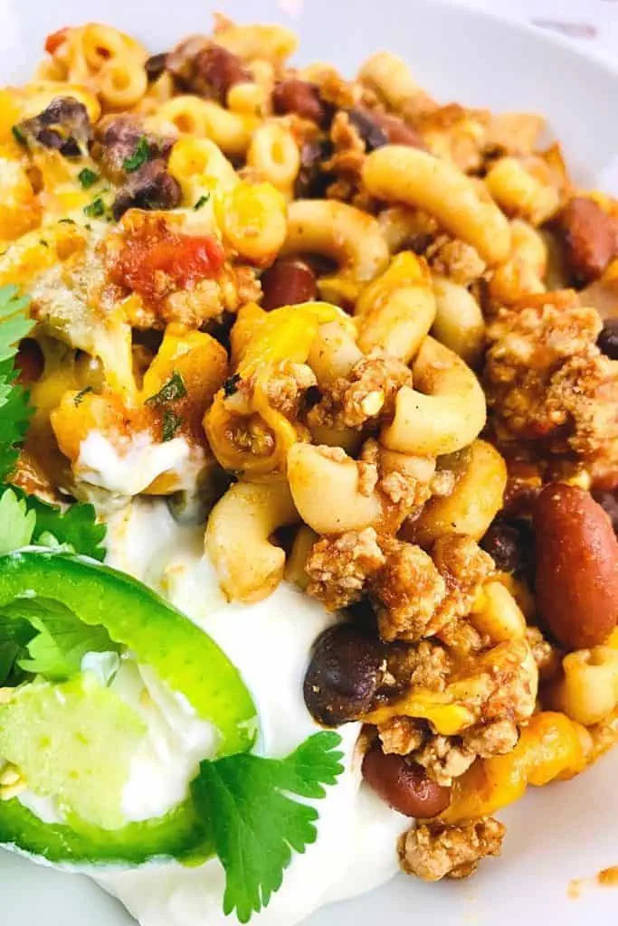 Prepare a fulfilling meal for the family with this wholesome and hearty Chili Mac. Loaded with flavor, this easy comfort food recipe is perfect to make for lunch or dinner with a side of cornbread or garlic bread! Chili Mac and Cheese is an easy weeknight meal idea.