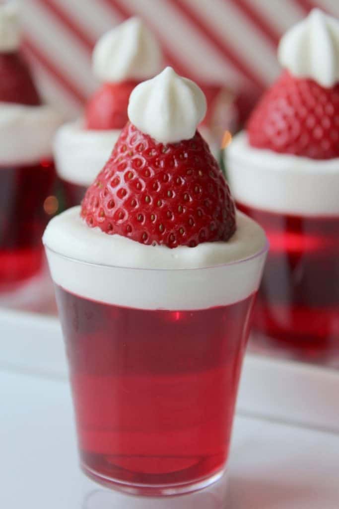 Bring in the celebration during the holiday season with these Santa Hat Jello Shots. This fun Christmas Jello Shot recipe tastes absolutely amazing! This easy jello shot recipe is a perfect holiday party recipe idea.