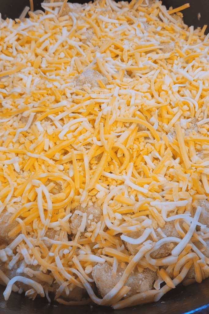 Image illustrates shredded cheese for tater tot casserole.