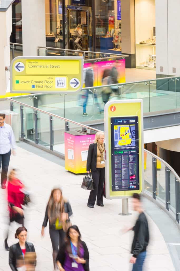 View through ground floor of Trinity Leeds Shopping centre showing the totem and directional sign design