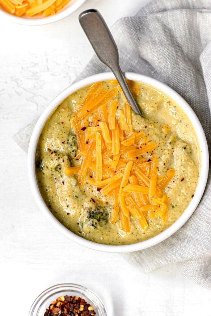 top shot of cheddar broccoli soup made in the instant pot topped with cheese