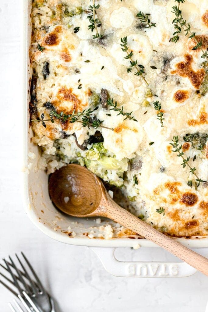 a scoop of casserole dipped out with the spoon in the baking dish
