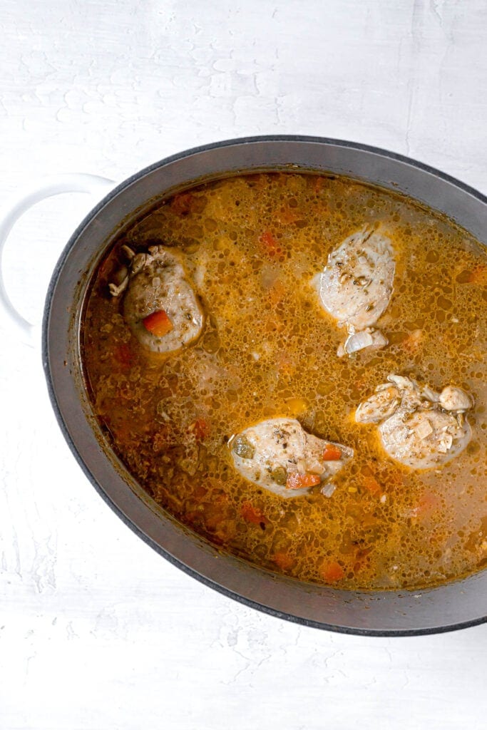 white chicken chili with broth poured in in a large stock pot