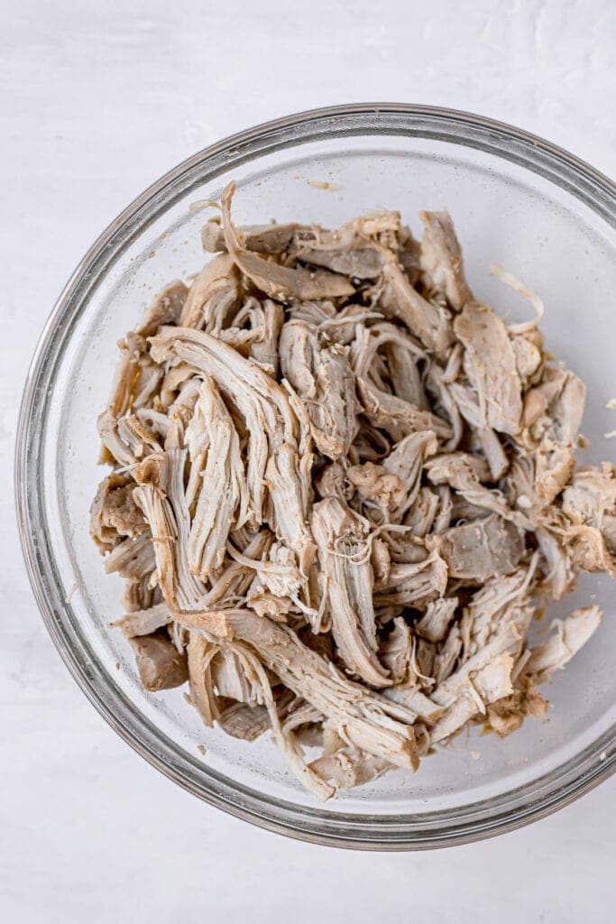 shredded chicken in a glass bowl