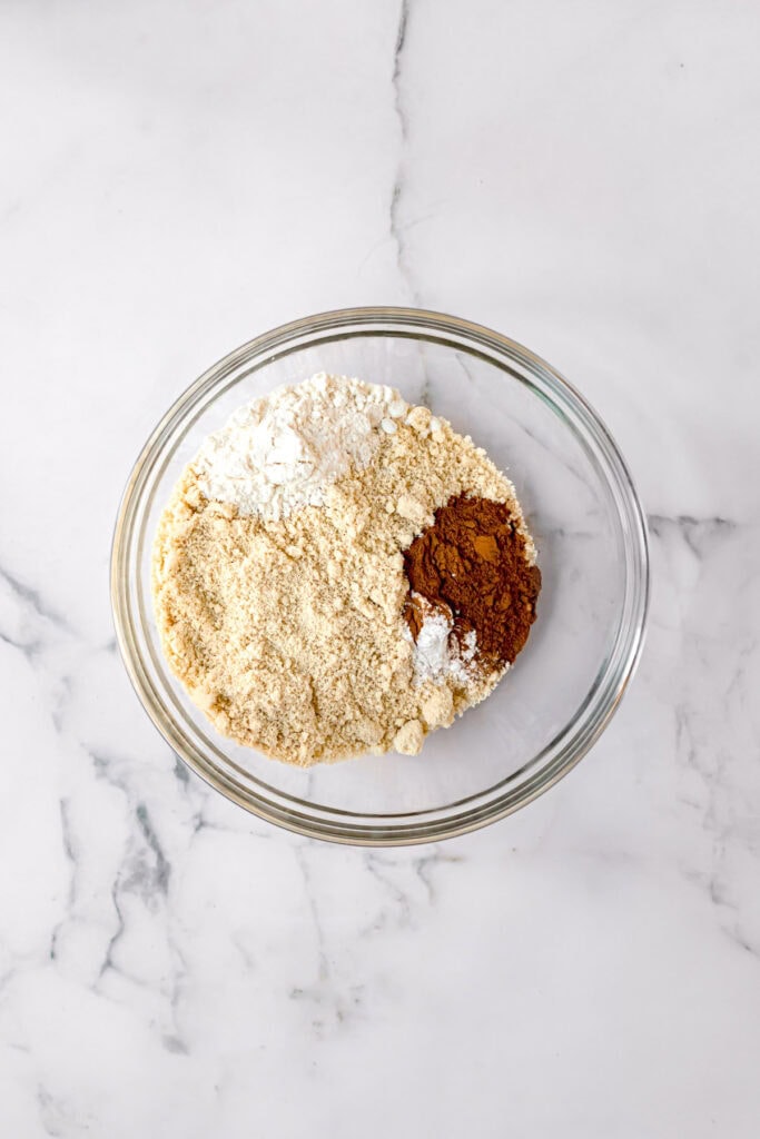 ingredients to make paleo carrot cake in a glass bowl