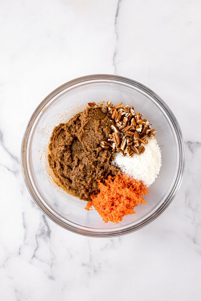 ingredients to make paleo carrot cake in a glass bowl