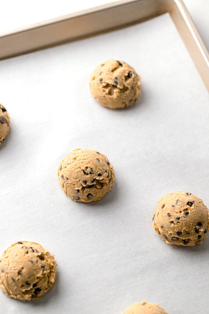 chilled dairy free cookie dough on a parchment lined baking sheet