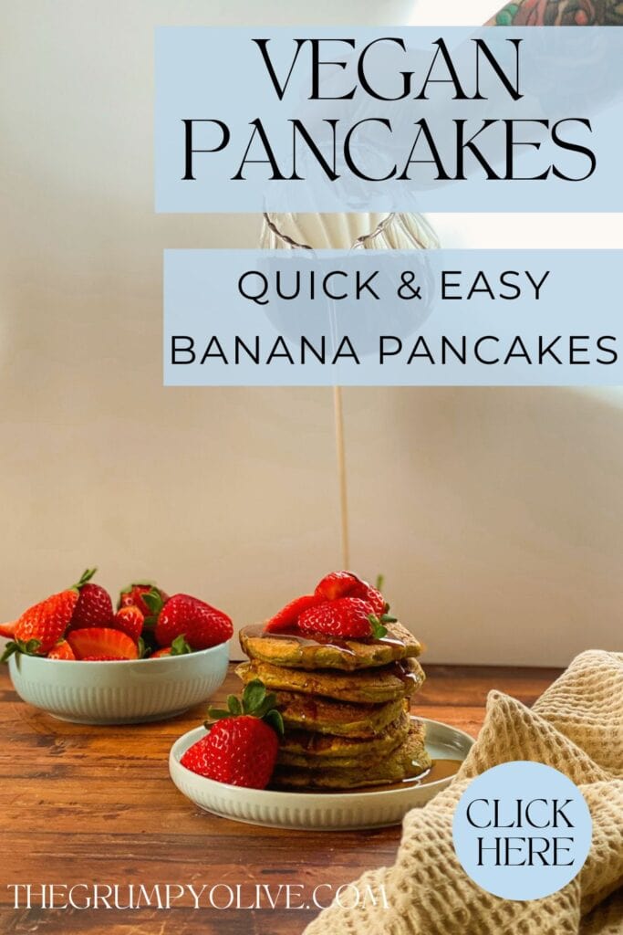 stack of vegan oat flour pancakes with maple syrup dripping on it and strawberries, wooden background