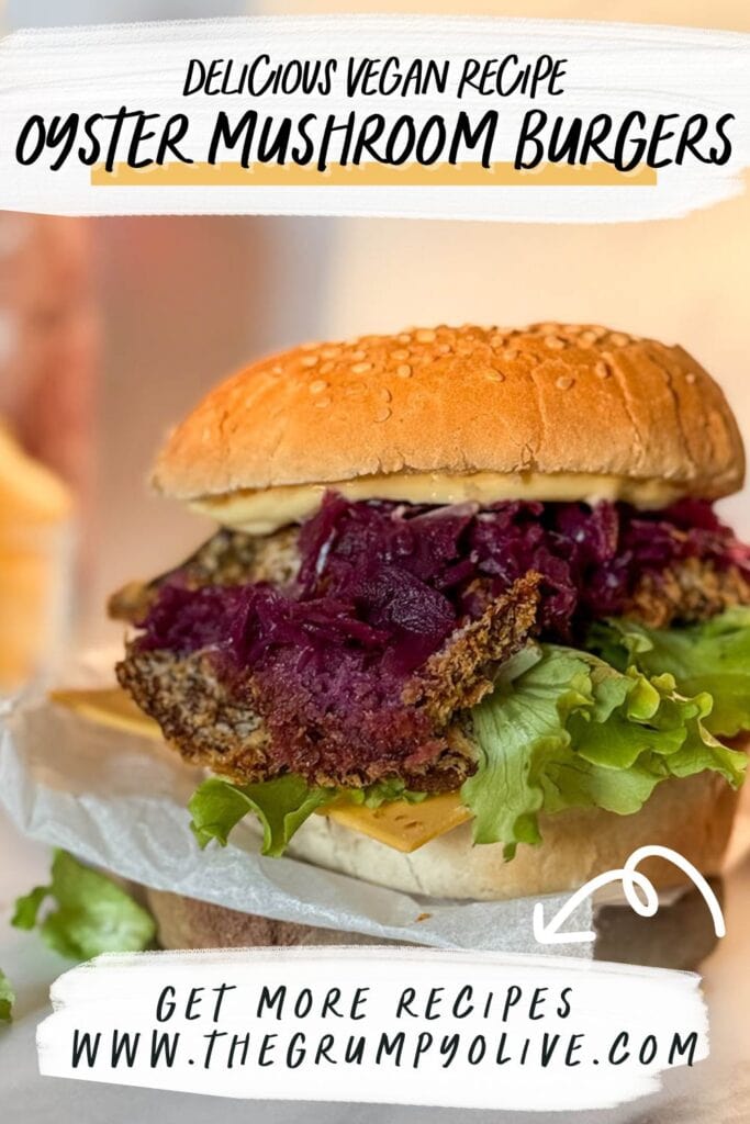 A promotional image of a vegan oyster mushroom burger with text reading "Delicious Vegan Recipe: Oyster Mushroom Burgers" and "Get More Recipes at www.thegrumpyolive.com," showcasing the burger's crispy mushroom patty, colorful toppings, and sesame seed bun.