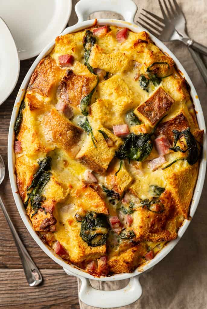 baked strata from overhead with spinach, ham, and gruyere cheese