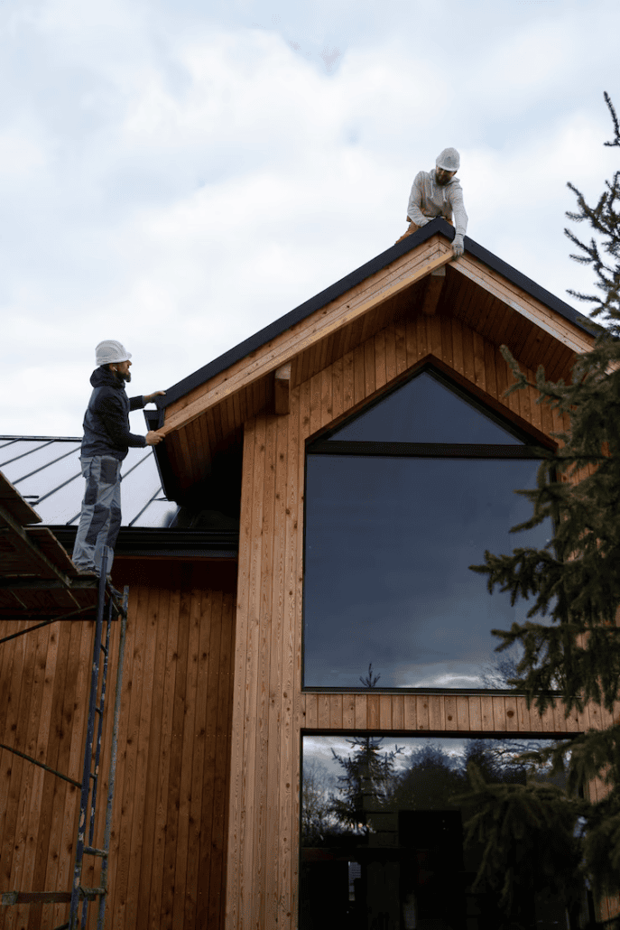 Skilled roofers working on the installation of a roof. Get a free estimate today by contacting us.