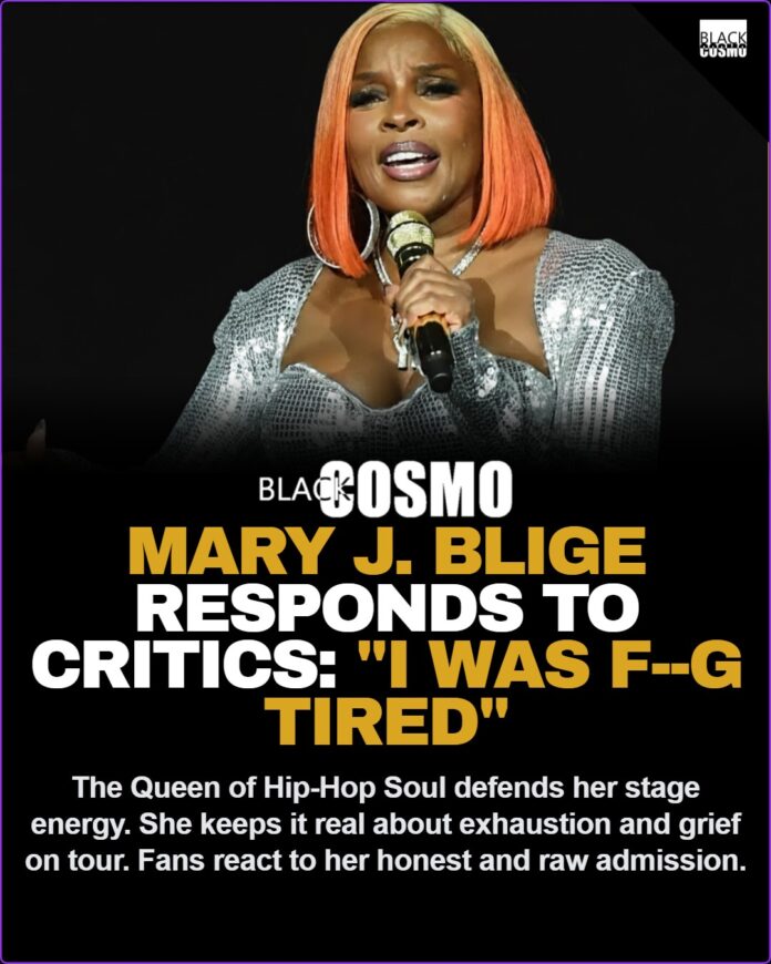 Mary J Blige performing live on stage holding a microphone