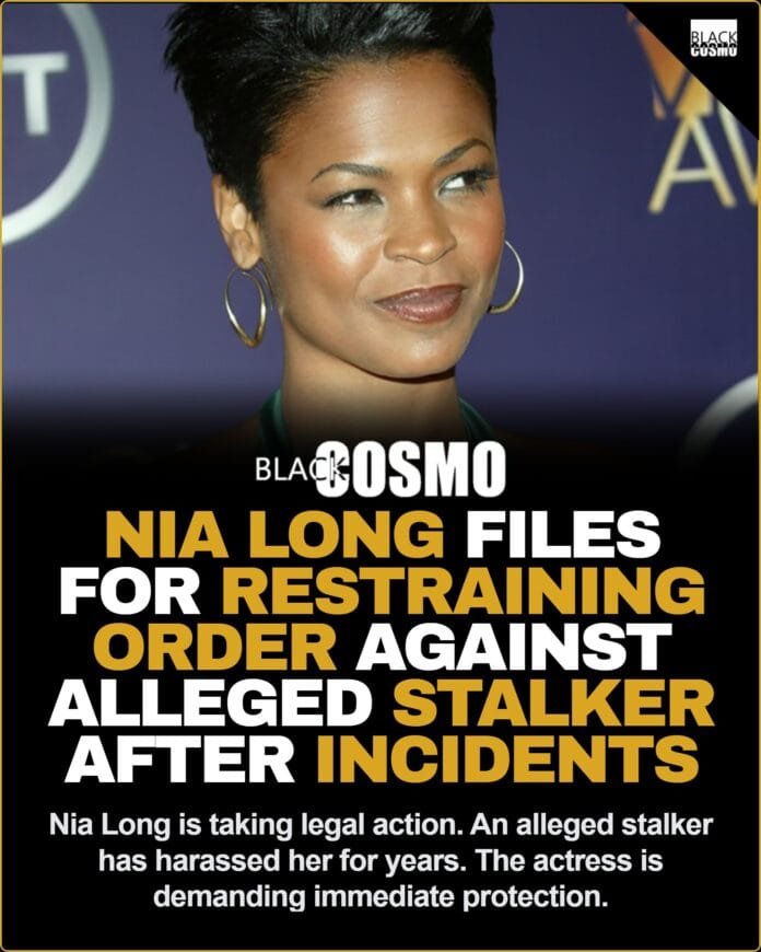 Actress Nia Long smiling confidently on a red carpet event