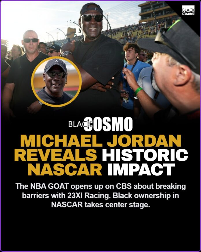 Michael Jordan smiling while wearing a 23XI Racing headset at a NASCAR track