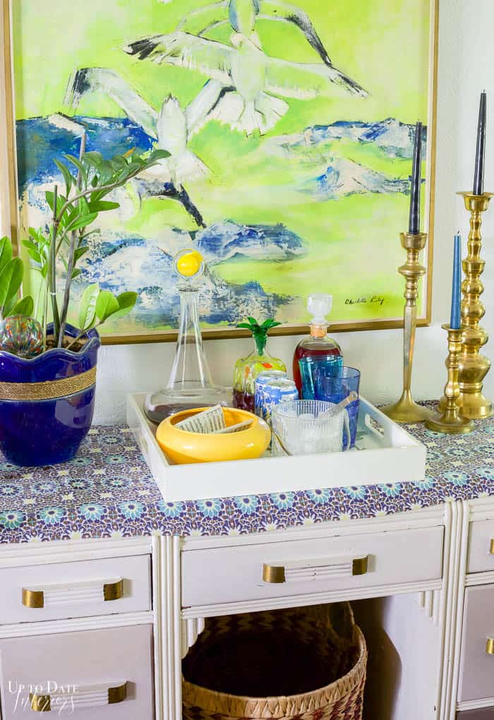 Bright blue and green bird art with bar setup