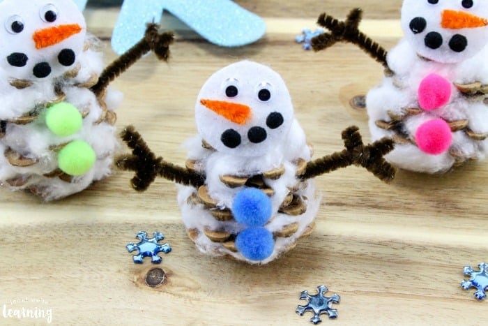 snowmen made with pine cones and pom poms