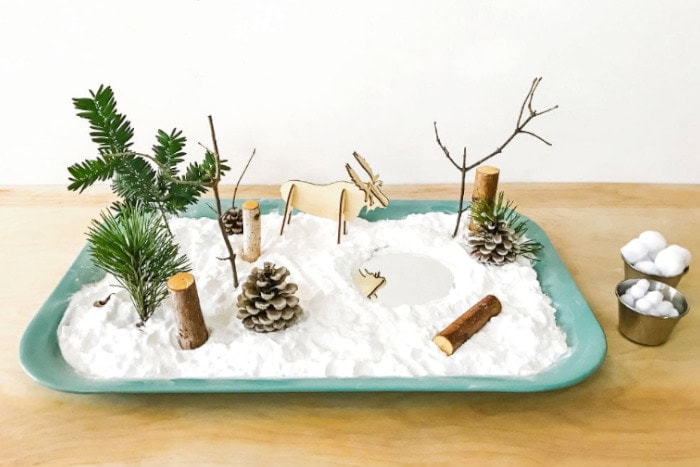 Winter themed sensory garden featuring a green bin and fake snow