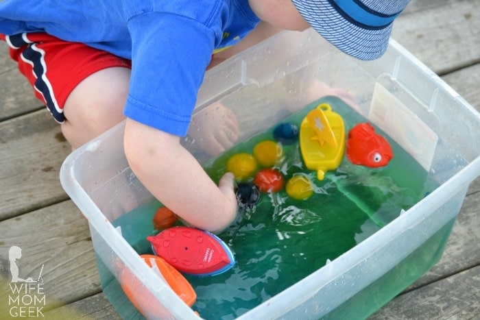 sensory bin with water and colored ice