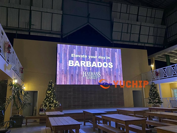 Featured image of the outdoor LED display at a hotel in Barbados showing “Elevate your day in BARBADOS” advertisement with festive Christmas decorations