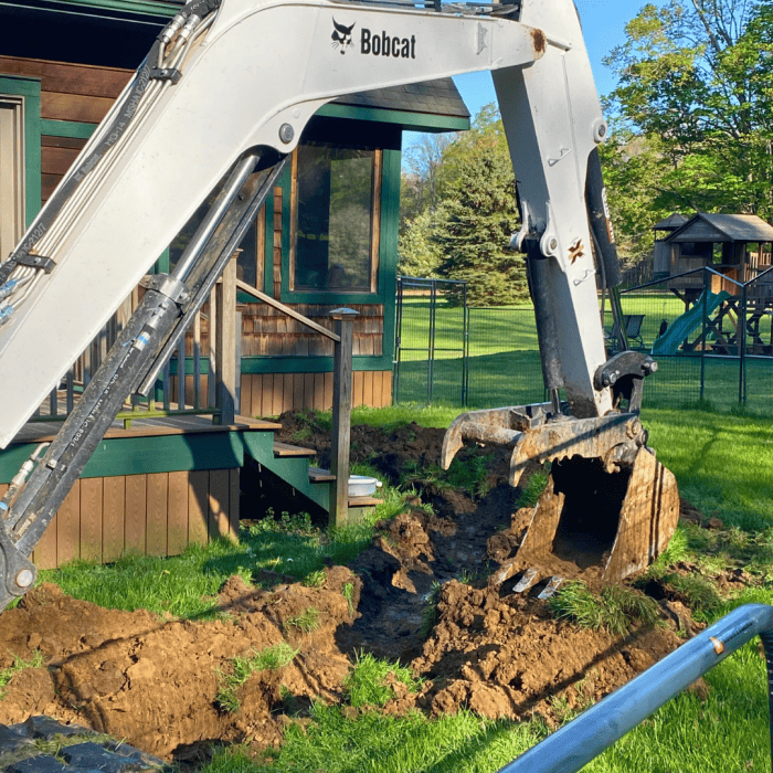 RCS excavator digging next to a house