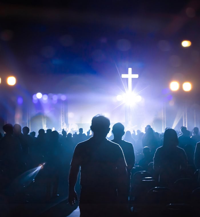The cross amid a church filled with people. Find Answer to Mental Health with God