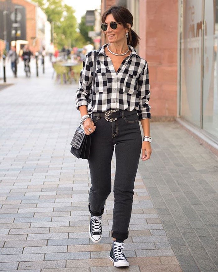 Patricia wearing a check shirt, jeans and sneakers | 40plusstyle.com
