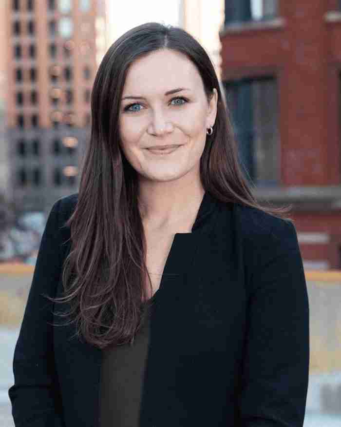 Hannah Heebner, LMSW CCTP, IFS therapist in Michigan for chronic pain and trauma, in a professional headshot wearing a dark blazer
