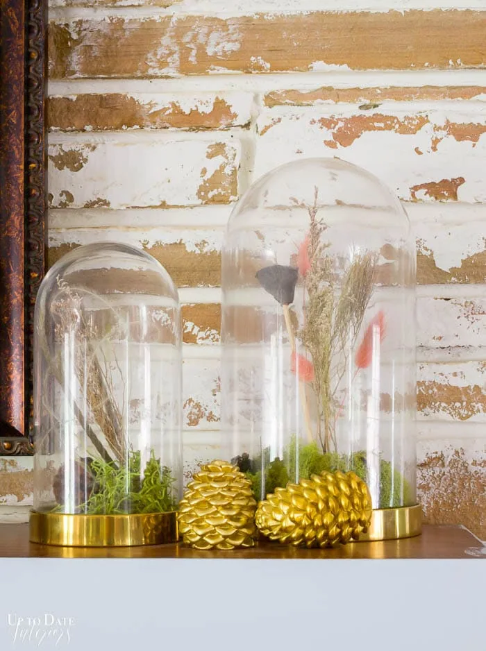 Eclectic Home Tour For Fall fireplace mantel with gold pinecones and Fall dried flowers in cloches