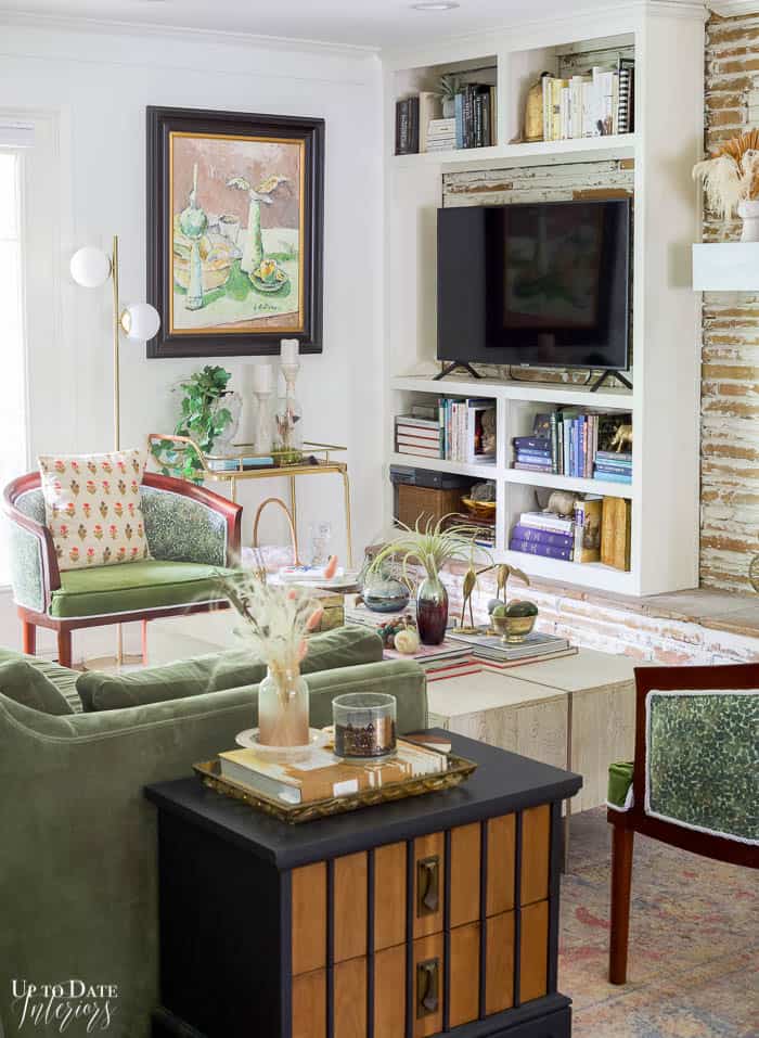 Green and White Living Room with german smear fireplace. Maximalist style.