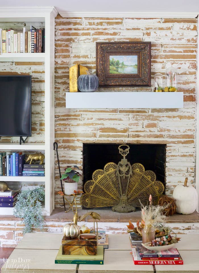 View of Fall decorated Fireplace and coffee table with colorful and eclectic decor.