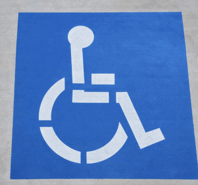 Blue ADA handicap parking stall with white accessibility symbol