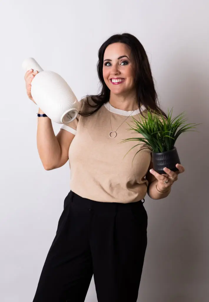 Jaydee Sheppard Realtor in Placer County holding home decor vase and plant, symbolizing staging and preparing homes for sale - Jaydee Sheppard Real Estate Jaydee Sheppard Realtor in Placer County holding home decor vase and plant, symbolizing staging and preparing homes for sale