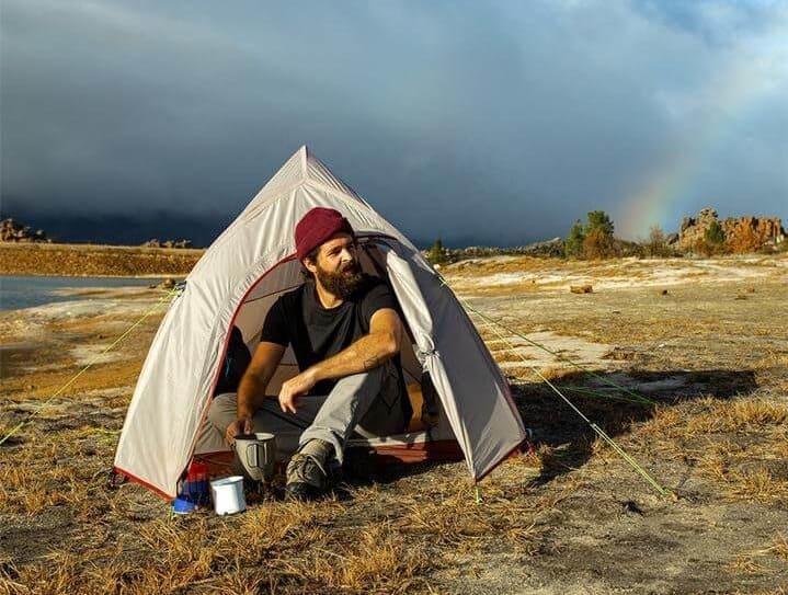camper sitting in the front of Naturehike cloud up tent