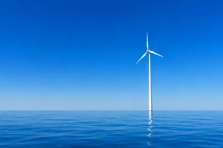 single wind turbine on a calm sea