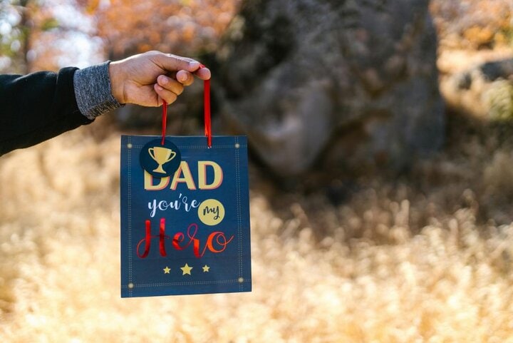 Holding a Father's Day gift outside