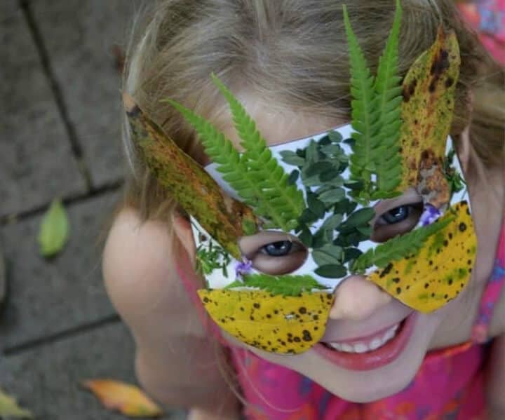 girl wearing a DIY mask made with leaves and flowers