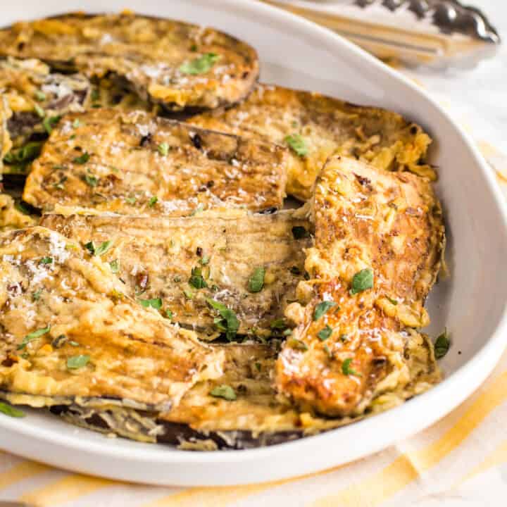 platter of pan-fried eggplant with tongs