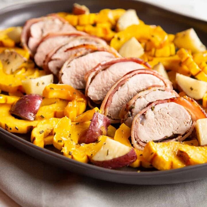 bacon-wrapped pork tenderloin slices with delicata squash and potatoes