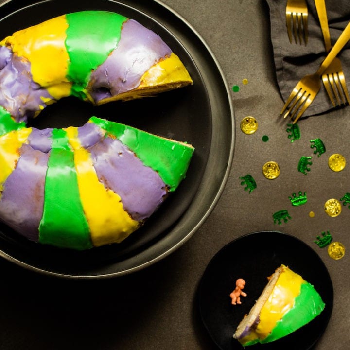 Mardi Gras king cake, the traditional tricolored dessert hailing from New Orleans, is a good-luck charm for the New Year. Make your own homemade cake with cream cheese filling. #mardigras #kingcake