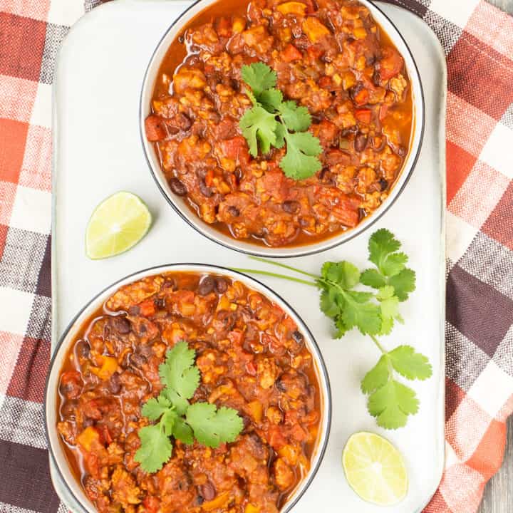 Black bean chili with cilantro brings a summery dimension to the fall/winter comfort staple, but can be made without the herb for cilantro haters.